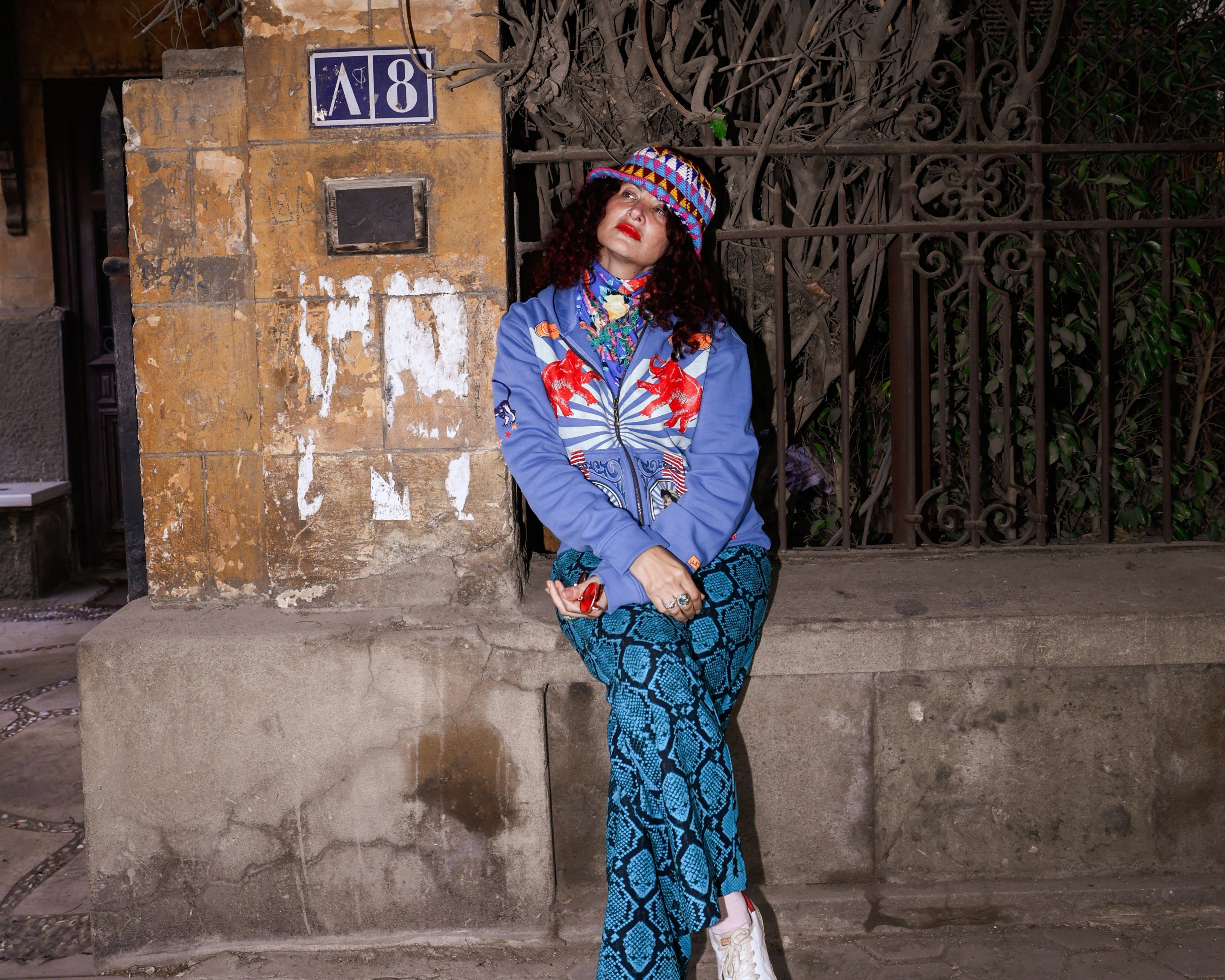Blue Tamr Henna Unisex Jacket – Designer wearing henna-embroidered blue zip-up hoodie at night – Cairo Works Egyptian streetwear
